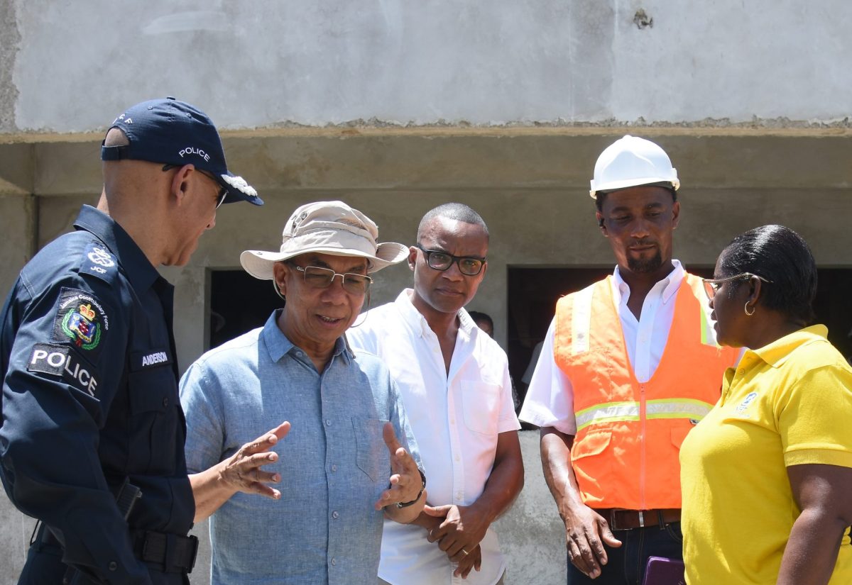 Deputy Prime Minister and Minister of National Security, Hon. Dr. Horace Chang (second left), holds discussions with (from left), Police Commissioner, Major General Antony Anderson; Member of Parliament, Westmoreland Western, Morland Wilson; Manager,Marlon Turner Construction, Marlon Turner; and Senior Project Manager in the National Housing Trust’s (NHT) Special Projects Unit , Jacqueline Johnson. The occasion was a recent tour of the Frome and Little London Police stations’ construction sites in Westmoreland.

