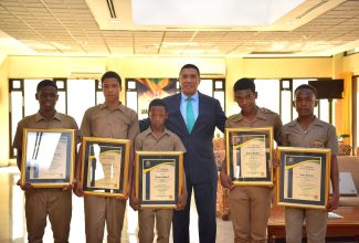 Prime Minister, the Most Hon. Andrew Holness (third right), is flanked by the five students of B.B. Coke High School in St. Elizabeth who, on September 28, rendered care to their grievously injured schoolmate, Jaheim Powell. From left are Daejuan Gordon, Khari Green, Dejaun Powell, Garry Bartley and Leon Barnes. The occasion was a visit to Jamaica House on Tuesday (October 3) where the students were presented with laptops and citations.