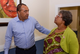 Minister of Health and Wellness, Dr. the Hon. Christopher Tufton, converses with Executive Director, Caribbean Public Health Agency (CARPHA), Dr. Joy St. John, during yesterday’s (October 24) project launch of the ‘Using District Health Information System 2 (DHIS2) to strengthen cancer registration data systems in low-resourced countries: from Rwanda to Jamaica’, at The Jamaica Pegasus hotel in New Kingston.