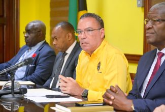 Minister of Science, Energy, Telecommunications and Transport, Hon. Daryl Vaz (second right), addresses a Press Conference at the Ministry of Science, Energy, Telecommunications and Transport on October 12.  With the Minister are (from left) Director General of the Island Traffic Authority, Col. Daniel Pryce; Managing Director of the Transport Authority, Ralston Smith and Chairman of the Transport Authority, Owen Ellington. The Press Conference was called to update the public on matters pertaining to the fare adjustment for public passenger vehicles, which will take effect on Sunday, October 15.

