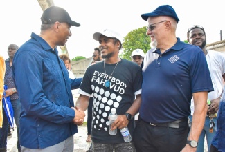 Prime Minister, the Most Hon. Andrew Holness (left), greets participant in the Project STAR (Social Transformation and Renewal) initiative, Akeem Tate  (centre), during a tour of Parade Gardens in downtown Kingston recently. They are joined by Project STAR Co-Chair and sponsor, Keith Duncan.