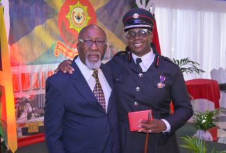 Former Commissioner of the Jamaica Fire Brigade (JFB), Frederick Whyte (left), who will be recognised for 40 years of outstanding contribution to the institution at the National Honours and Awards ceremony on National Heroes Day on October 16, shares a moment with Assistant Commissioner, JFB, Julian Davis Buckle. Mr. Whyte was instrumental in Mrs. Davis-Buckle’s career at the JFB.