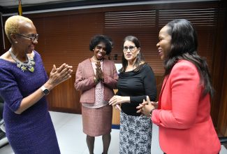 Minister of Education and Youth, Hon. Fayval Williams (left), shares pleasantries with Chief Education Officer (Acting), Dr. Kasan Troupe (right), during the launch of the Inter-American Development Bank’s (IDB) Teachers’ Digital Skills Project. The ceremony was held at the Education Ministry’s offices in Kingston on Wednesday (October 4). Sharing the moment are (from second left) Chief Executive Officer, Jamaica Teaching Council, Dr. Winsome Gordon, and Senior Director, International Society for Technology in Education (ISTE) Standards, Carolyn Sykora.

