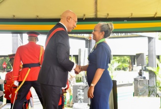 Governor-General, His Excellency, the Most Hon. Sir Patrick Allen, presents Permanent Secretary in the Ministry of Labour and Social Security, Colette Roberts Risden, with the Order of Distinction in the rank of Commander (CD) for outstanding contribution to the Public Service, during the Ceremony of Investiture and Presentation of National Honours and Awards, held on the lawns of King’s House on Monday (October 16).


