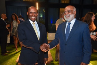 Minister of Industry, Investment and Commerce, Senator Hon. Aubyn Hill (left), shakes hands with General Manager, Country Department Caribbean Group and Country Representative, Jamaica, Inter-American Development Bank (IDB), Anton Edmunds, during the IDB’s Sub-Regional Policy Dialogue network forum cocktail reception at the AC Hotel by Marriott Kingston on Wednesday (October 18).

