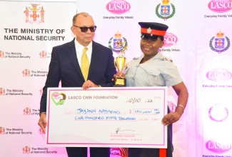 2023 Lasco Top Cop, Woman Constable Jayann Raymond, receives a cheque for $150,000 from Executive Chairman of Lasco Affiliated Companies, James Rawle. Occasion was the LASCO/Jamaica Constabulary Force (JCF) ‘Saluting Our Heroes’ awards ceremony held on Friday (Oct. 20) at the AC Marriott Hotel in New Kingston.