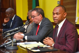 Transport Authority Managing Director, Ralston Smith (right), addresses a press conference held at the Ministry of Science, Energy, Telecommunications and Transport’s Maxfield Avenue offices in Kingston on Tuesday (October 24). Also pictured (from left) are Transport Authority Chairman, Owen Ellington; Permanent Secretary in the Ministry, Carol Palmer; and Portfolio Minister, Hon. Daryl Vaz.

 