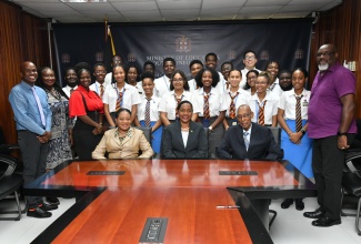 Minister of State in the Ministry of Education and Youth, Hon. Marsha Smith (seated centre); Deputy Chief Education Officer, Core Curriculum and Support Services Unit in the Ministry, Dr. Clover Hamilton Flowers (seated left) and Honorary Consul of Barbados, Winston Bayley (seated right), as well as students and staff members from Ardenne High School and the Harrison College in Bridgeport, Barbados share a photo opportunity, during a visit to the Ministry’s  Heroes Circle offices in Kingston on October 26. Students from Harrison College are participating in a one-week student exchange with Ardenne High, which is aimed at enhancing learning and teaching methodologies and further improve overall student achievement.