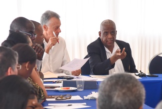 Minister of State in the Ministry of Agriculture, Fisheries and Mining,  Hon. Franklin Witter (right), addresses a meeting of the Bauxite Subcommittee of the Manchester Parish Development Committee (MPDC) held on Friday (October 27), at the Tropics View Hotel in Mandeville. Seated next to the Minister is Chairman of the MPDC,  Anthony Freckleton.

