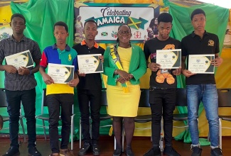 Senior Teacher and Civic Empowerment/Culture Agent at the St. Elizabeth-based Ballard’s Valley Primary School, Rosemarie Steele (third right), is flanked by the five BB Coke High School male students who acted swiftly in getting their injured schoolmate to a medical facility on September 28. The occasion was a recent ceremony at Ballard’s Valley Primary where the students were honoured. They are from left: Dejuan Powell, Daejuan Gordon, Leon Barnes, Garry Bartley, and Khari Green.

