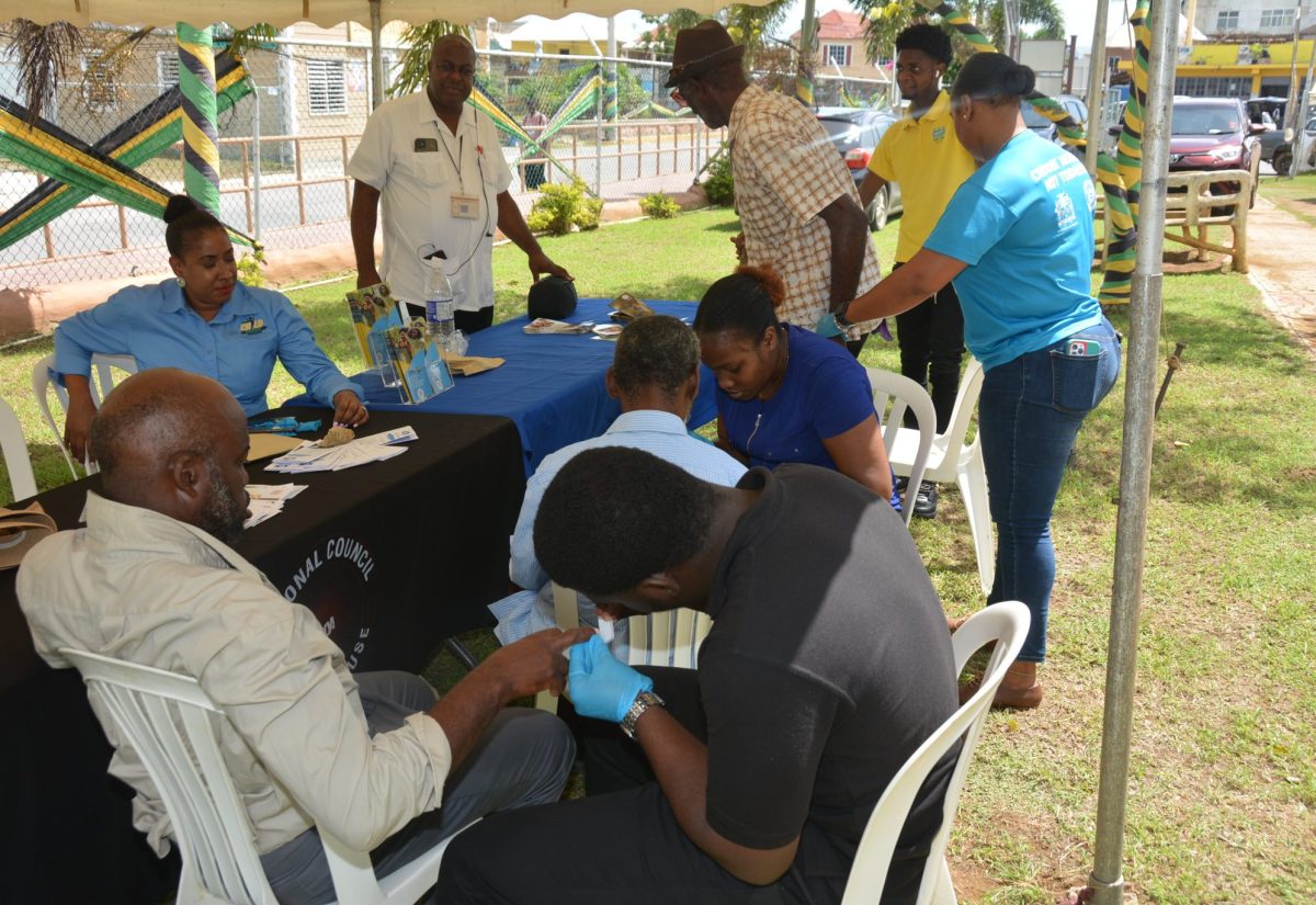 Personnel from the Poor Relief Department at the St. Elizabeth Municipal Corporation are providing nail-grooming services to homeless persons in the parish, during a World Homeless Day activity in Black River on Tuesday, October 10.