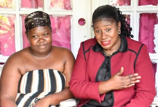 Regional Director at the Ministry of Education and Youth – Region 3 – Karlene Segre (right), gives words of encouragement to Jessica Taylor, the mother of slain 8-year-old Talia Thompson, during a visit to her home in Discovery Bay, St. Ann, on Tuesday (October 3). Also visiting the home were representatives from the Child Protection and Family Services Agency (CPFSA),  Northeast Region.

