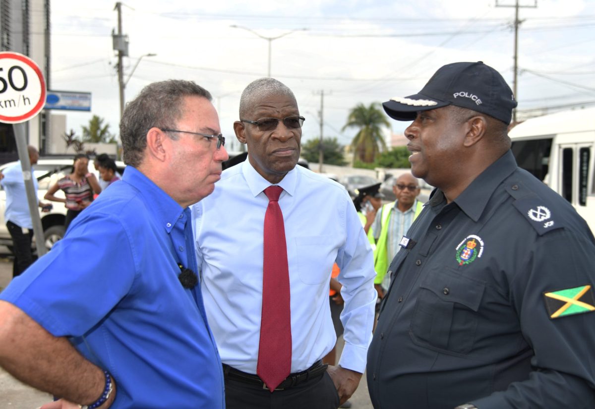 Minister of Science, Energy, Telecommunications and Transport, Hon. Daryl Vaz (left), is in conversation with Head of the Jamaica Constabulary Force (JCF) Public Safety and Traffic Enforcement Branch (PSTEB), Assistant Commissioner of Police (ACP) Gary McKenzie (right) and Chairman of the Transport Authority (TA), Owen Ellington. Occasion was a tour of sections of the Corporate Area on Monday (October 9), as part of activities under ‘Operation Streamline,’ which aims to  rid the streets of rogue taxi drivers.