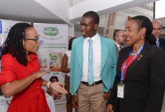 Minister of State in the Ministry of Education and Youth, Hon. Marsha Smith (right), converses with Press Secretary, Office of the Prime Minister, Naomi Francis, and Jamaica Prefects Association Vice President for Region 7, Kamar Edwards, during the 97th Inter-American Children’s Institute (IIN) Directing Council Meeting opening ceremony on Wednesday (October 25) at the Jamaica Conference Centre in downtown Kingston.