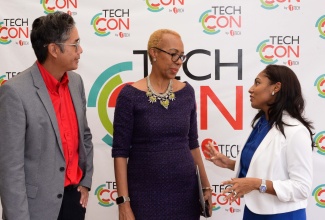 Minister of Education and Youth, Hon. Fayval Williams (centre), interacts with tTech Marketing and Sales Manager, Marsha Bucknor (left) and Chief Executive Officer (CEO), Norman Chen, during the sixth annual TechCon Conference at the Summit in New Kingston on Wednesday (October 4).

