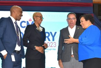 Minister of Education and Youth, Hon. Fayval Williams (second left); Minister of Science, Energy, Telecommunications and Transport, Hon. Daryl Vaz  (second right); and President, Caribbean Maritime University (CMU), Professor Andrew Spencer (left), engage with Chief Executive Officer, Seaboard Jamaica and Member, CMU Council, Corah Ann Robertson Sylvester, during the third staging of the University’s industry conference at the Jamaica Conference Centre in downtown Kingston on September 28.

