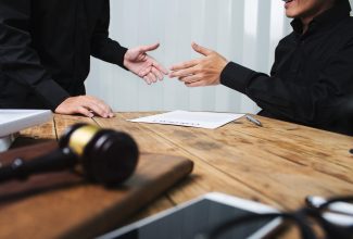 A team of lawyers discuss the details of a case of the accused. 