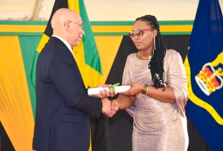 Governor-General, His excellency the Most Hon. Sir Patrick Allen (left), receives the citation for the 2023 Jamaica Civil Service Long Service Awards from President of the Jamaica Civil Service, Techa Clarke- Griffiths. The ceremony was held on November 22 at King’s House.

