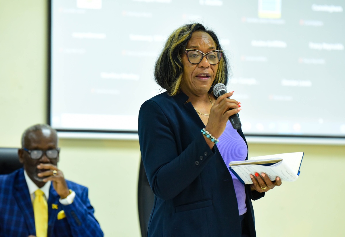 Director of Standards, Bureau of Standards Jamaica, Julia Bonner Douett, speaks during a meeting of the National Disaster Risk Management Council on Tuesday (October 31), at the Ministry of Local Government and Community Development, on Hagley Park Road in Kingston. Listening is Minister of Local Government and Community Development, Hon. Desmond McKenzie.
