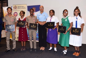 Minister of Education and Youth, Hon. Fayval Williams (centre) with the top performing students in the Primary Exit Profile (PEP) examinations, during an awards ceremony held on November 3, at the Jamaica Pegasus Hotel in Kingston.