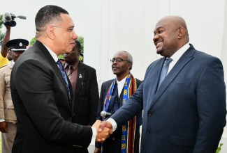 Prime Minister, the Most Hon. Andrew Holness (left), is greeted by Co-Chair, Hanover Tricentenary Committee, Reverend Glenroy Clarke, prior to the start of the Ecumenical Worship Service to kick-start celebrations for Hanover