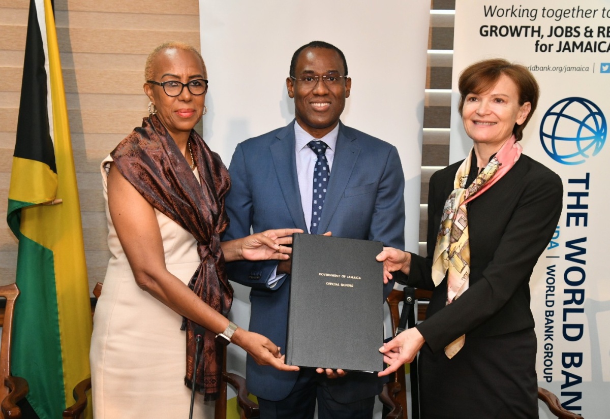 Minister of Finance and the Public Service, Dr. the Hon. Nigel Clarke; Minister of Education and Youth Hon. Fayval Williams (left), and Country Director, Caribbean Countries, World Bank, Lilia Burunciuc, display the Jamaica Education Project (JEP) Loan Agreement during a visibility ceremony held at the Ministry’s Heroes Circle offices in downtown Kingston, on November 20.
