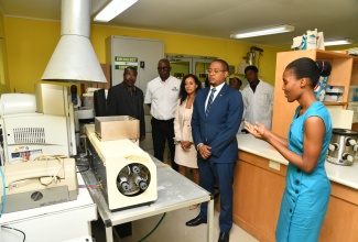 Minister of Agriculture, Fisheries and Mining, Hon. Floyd Green (second left), looks on as Senior Veterinary Biochemical Analyst for the Ministry’s Veterinary Services Division, Georgette Thompson, highlights features of equipment used in the division. Others (from left) are Chief Veterinary Officer, Dr. Osbil Watson; Chief Technical Director in the Ministry, Orville Palmer; and Pan American Health Organization (PAHO)/World Health Organization (WHO) Advisor, Health, Surveillance, Disease Prevention and Control, Dr. Serene Joseph. Occasion was the Ministry’s World Anti-Microbial Awareness Week event held on November 21 at the Veterinary Services Division in Kingston.

