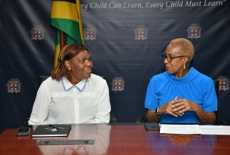 Minister of Education and Youth, Hon. Fayval Williams (right), shares in conversation with Deputy Minister of Sports, Arts and Culture, Republic of South Africa, Hon. Nocawe Mafu. A delegation from South Africa called on the Minister at her National Heroes Circle offices in Kingston on November  22.

