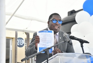 Regional Director for Region Six, Ministry of Education and Youth, Barrington Richardson addresses a ceremony for the handover of a 1,000-gallon water tank to the Kellits High School in Clarendon on Monday (November 27). The donation of the water tank is part of Courts’ islandwide black tank initiative, aimed at improving water storage capacity at various schools.