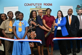 Minister of Education and Youth, Hon. Fayval Williams (fourth left), and Speaker of the House of Representatives, the Most Hon. Juliet Holness (fourth right), cut the ribbon to officially open the renovated computer room at Clan Carthy Primary School in Kingston on Tuesday (November 28). Among those sharing the occasion (from left) are Head Boy, Jhoneal Johnson; Head Girl, Jameliha Clarke; Principal, Winsome Reid; Ambassador of the Dominican Republic to Jamaica, Her Excellency Angie Martinez; and Member of Parliament, St. Andrew South Eastern, Julian Robinson.

