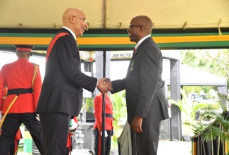 Governor-General, His Excellency the Most Hon. Sir Patrick Allen, presents the Badge of Honour for Meritorious Service in the fields of Religion, Volunteerism and Community Development to Pastor of The Door Christian Fellowship Church, Patrick Anthony Jordan. Occasion was the National Honours and Awards Ceremony held at King’s House on October 16.

