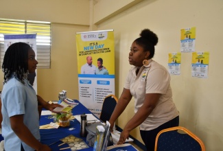 Child Diversion Officer for St. Ann, Christina Plunkett (right), engages Moneague College student, Amani Miller, during a Government Services Fair held at the institution on Friday (October 27). The event, organised by the Public Sector Modernisation Division (PSMD), Office of the Cabinet, formed part of activities to mark Service Excellence month in October.