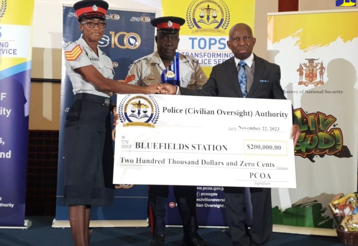 Board Member of the Police Civilian Oversight Authority (PCOA), Pastor Glen Samuels (right), presents a cheque to Sub-Officer in Charge of the Bluefields Police Station in Westmoreland, Sergeant Monique Leslie-Hamilton (left), and second in command, Corporal Rupert Dixon. The occasion was the PCOA’s Transforming Our Police Service (TOPS) Area One Awards ceremony, which was held at the Montego Bay Convention Centre in St. James on Wednesday (November 22). Bluefields received the award for Top Police Station in the division.