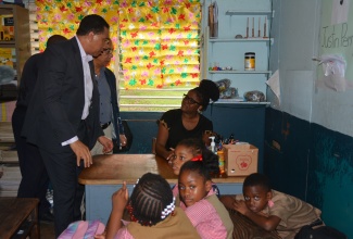 Prime Minister, the Most Hon. Andrew Holness (left) and Deputy Prime Minister and Minister of National Security, Hon. Dr. Horace Chang, console teacher Marila Nation, who taught one the two slain students of Chetwood Memorial Primary and Infant School in St. James, during a visit to the institution on Thursday, November 9.

 