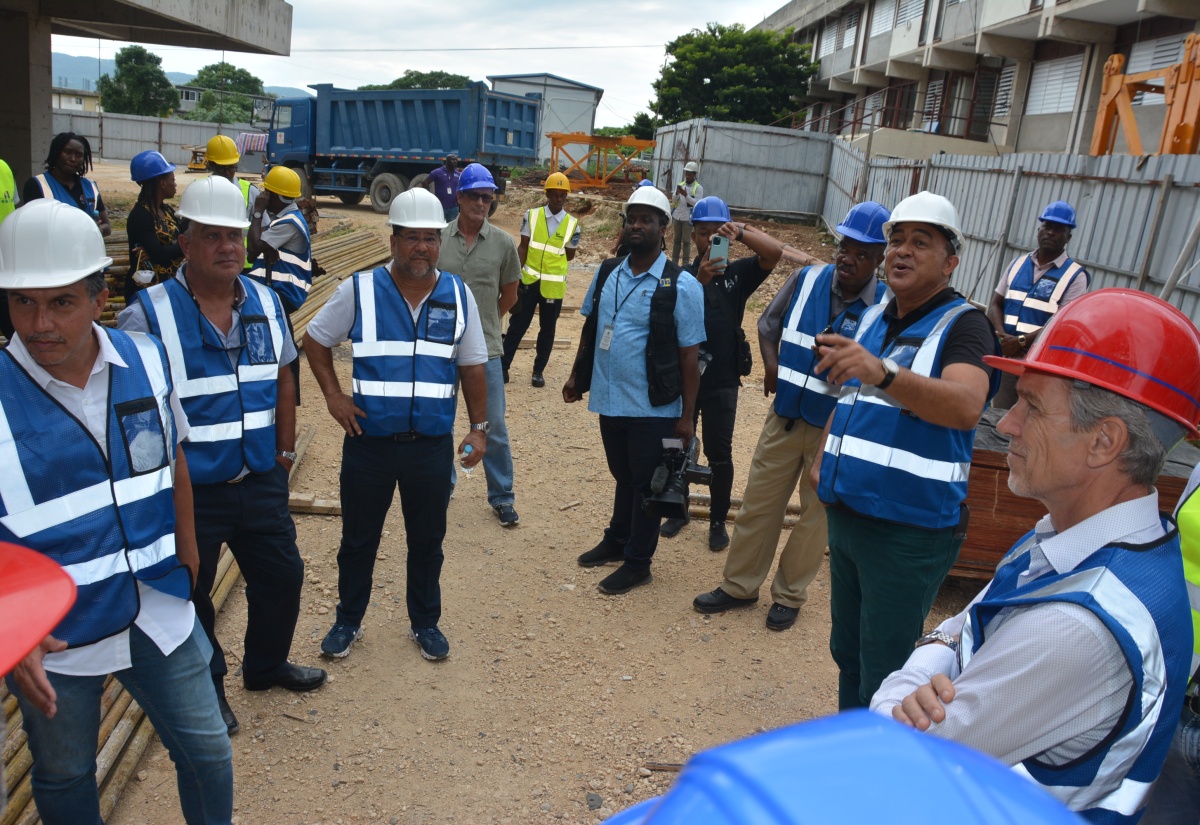 Minister of Health and Wellness, Dr. the Hon. Christopher Tufton, points out something of interest during a tour of the Western Children Adolescent Hospital project site with members of the Montego Bay business community on Tuesday (November 28).