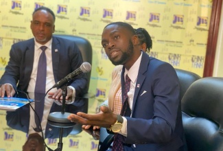 Project Manager, Jamaica Social Investment Fund (JSIF), Dane Mclean (right) shares information about the Disaster Vulnerability Reduction Project (DVRP) during a recent Jamaica Information Service (JIS) Think Tank at the agency’s head office in Kingston. Listening is Managing Director, JSIF, Omar Sweeney.

