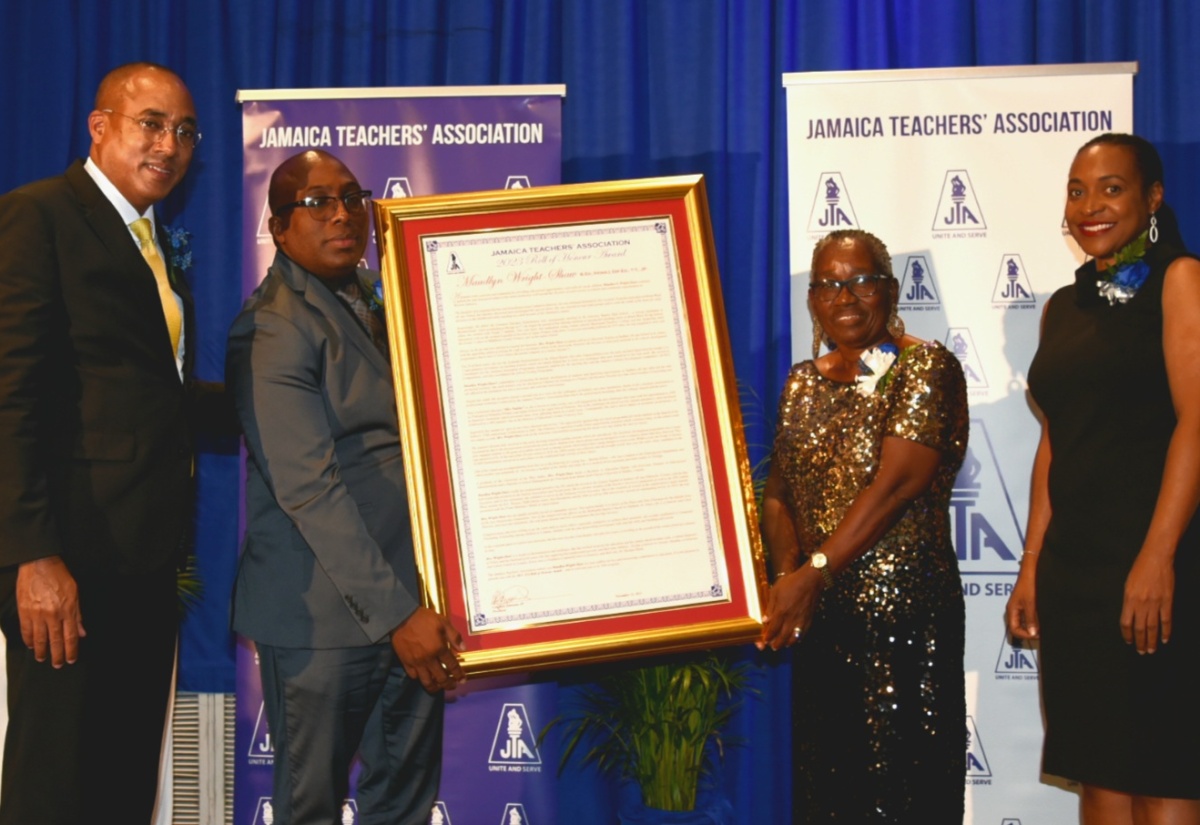 Minister of State in the Ministry of Education and Youth, Hon. Marsha Smith (right), shares in the presentation of a framed citation to the Jamaica Teachers’ Association (JTA) 2023 Roll of Honour Awardee,  Maudlyn Wright Shaw (second right), at the recent awards ceremony held at The Jamaica Pegasus hotel in New Kingston. Making the presentation is JTA President, Leighton Johnson (second left), while Attorney-at-law, Peter Champagnie, who was the guest speaker, also shares the moment.

