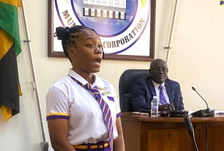 Deputy Junior Mayor and Junior Councillor for the Sandy Bay Division, Jada Lewis of Hopewell High School, addresses the monthly meeting of the Hanover Municipal Corporation (HMC) on Thursday (November 9). Looking on is Chairman of the Hanover Municipal Corporation and Mayor of Lucea, Councillor Sheridan Samuels.