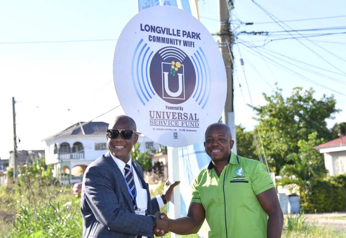 Labour and Social Security Minister and Member of Parliament for Clarendon South Eastern, Hon. Pearnel Charles Jr. (right), shakes hands with Chief Executive Officer, Universal Service (USF), Daniel Dawes, at the launch of the Longville Park Community Wi-Fi in the parish on November 24.