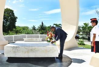 Minister without Portfolio with responsibility for Information, Hon. Robert Morgan, places flowers at the shrine of late former Prime Minister, Sir Donald Sangster, at National Heroes Park in Kingston on October 26, to commemorate the 112th anniversary of his birth. Sir Donald Sangster, who was Jamaica’s second Prime Minister, died on April 11, 1967 at age 55, just months after taking office on February 22, 1967.

