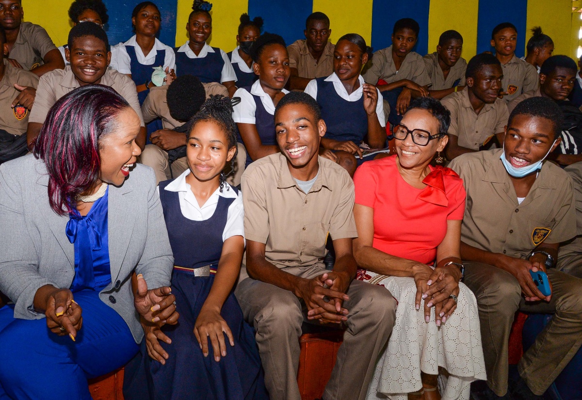 Permanent Secretary in the Ministry of Education and Youth, Dr. Kasan Troupe (left, front row), and Chief Education Transformation Officer, Dr. Faith Alexander (second right, front row), share a photo opportunity with students during the inaugural Transforming Education for National Development (TREND) pop-up, held at St. Andrew Technical High School on Monday (November 7).