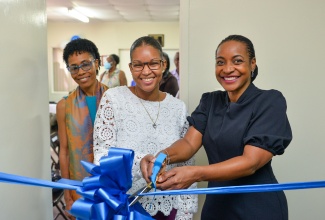 Minister of State in the Ministry of Education and Youth, Hon. Marsha Smith (right), cuts the ribbon to open the Lara Otunla Counselling Centre, located at the Foundation for International Self Help (FISH) Clinic in Kingston, on November 15. Sharing in the ribbon-cutting exercise (from left) are Manager for the Counselling Centre, Angelica Dalrymple; and Board of Management Chair, Candice Carby.

