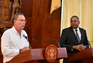 Minister of Science, Energy, Telecommunications and Transport, Hon. Daryl Vaz, addresses today’s (November 22) post-Cabinet press briefing at Jamaica House. Listening( at right) is Minister without Portfolio in the Office of the Prime Minister with responsibility for Information, Hon. Robert Morgan.


