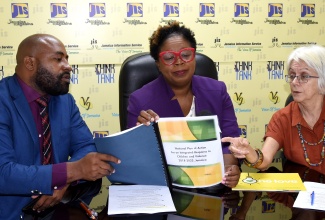 Senior Director, Children’s Affairs and Policy Division in the Ministry of Education and Youth (MOEY), Hyacinth Blair (centre); Director of Children and Family Programmes, Child Protection and Family Services Agency (CPFSA), Dr. Warren Thompson and Chair, Violence Prevention Alliance, Dr. Elizabeth Ward, peruse the MOEY’s National Plan of Action for an Integrated Response to Children and Violence (NPACV).  Occasion was a JIS Think Tank today (November 16).

 

