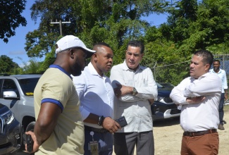 Minister without Portfolio in the Ministry of Economic Growth and Job Creation, Senator the Hon. Matthew Samuda (right); Minister of State in the Office of the Prime Minister and Member of Parliament for St. James Southern, Hon. Homer Davis (second right), converse with Acting President of the National Water Commission (NWC), Kevin Kerr (second left) and the NWC’s Regional Manager for St. James and Trelawny, Herman Fagan, during a recent visit  to the Cambridge water treatment facility. The Minister also toured water systems in the constituency.   

