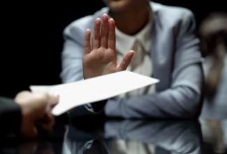 Female professional refuses to take bribe. 