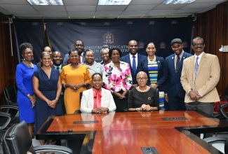 Minister of Education and Youth, Hon. Fayval Williams (right, seated), Permanent Secretary in the Ministry of Education and Youth (MOEY), Dr. Kasan Troupe (left, seated), and other sector stakeholders withthe LASCO/MOEY Principal and Teacher of the Year Competition finalists. The contestants paid a courtesy call at the Ministry in Kingston on Friday (December 1).