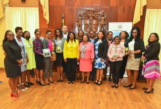 Cabinet Secretary, Hon. Audrey Sewell (centre), is flanked by top awardees in the Office of the Cabinet’s Front Office Décor Competition, at the awards presentation on December 21 at Jamaica House. The Ministry of Education and Youth received the first-place trophy.

