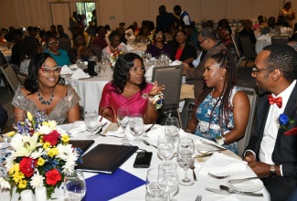 Cabinet Secretary, Audrey Sewell (second left), engages with General Secretary, Jamaica Civil Service Association (JCSA), Tifonie Powell Williams (second right), and Immediate Past President, JCSA, O