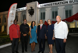 Minister of State in the Ministry of Education and Youth, Hon. Marsha Smith (third left) along with (from left) Campus Registrar, University of the West Indies (UWI) Mona Campus, Dr. Donovan Stanberry; Pro-Vice Chancellor and Principal, University of the West Indies, Mona Campus, Professor Densil Williams; Former Governor-General, His Excellency the Most Hon. Professor Sir Kenneth Hall and Lady Hall; and former Leader of the Opposition, Dr. Peter Phillips, share a photo opportunity at the official dedication ceremony for the Kenneth O. Hall Administrative Building held at the Undercroft, UWI Mona Campus, recently. Professor Hall, a former principal of the Mona campus, was instrumental in the construction of the administrative complex. 